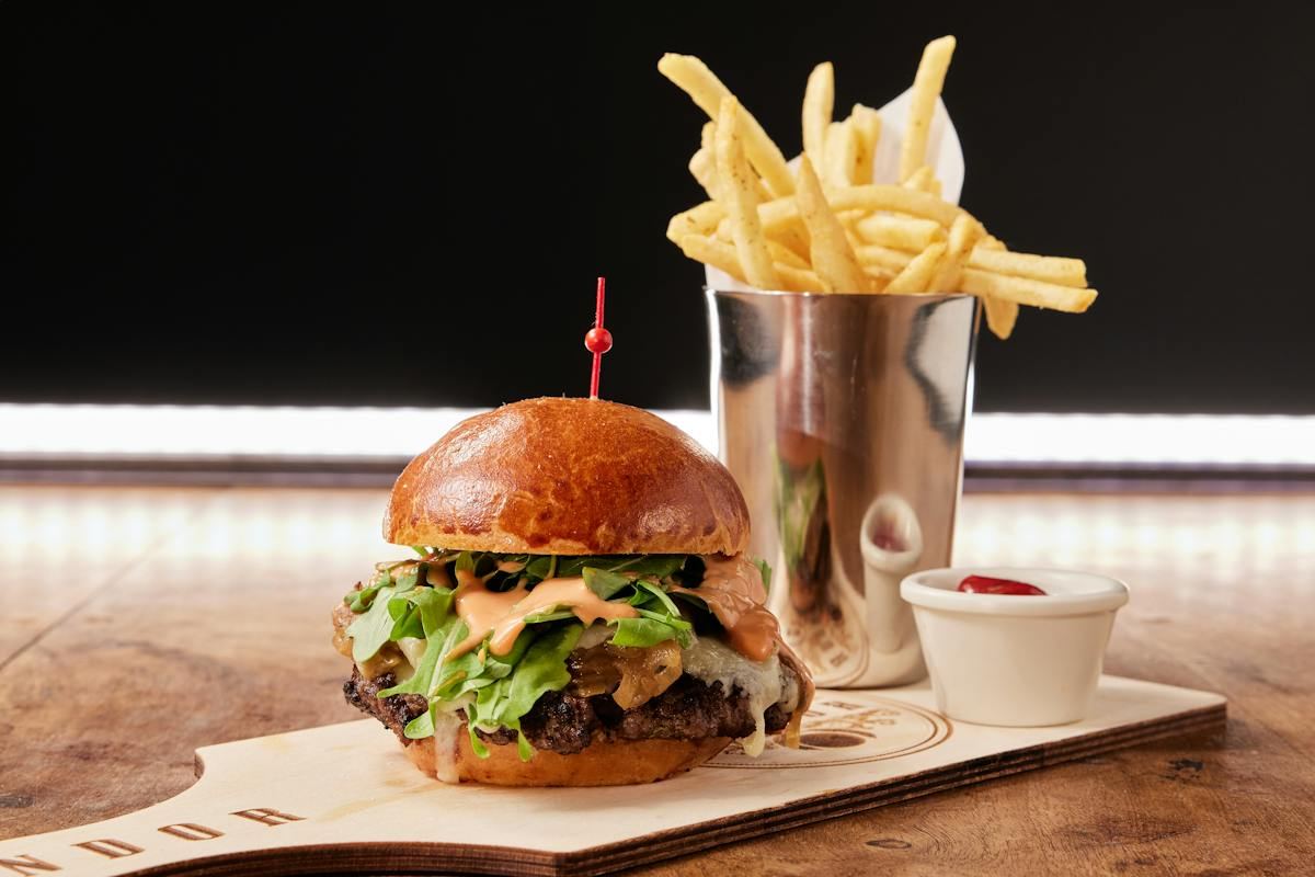 Brie burger with fries on a Pandor branded board